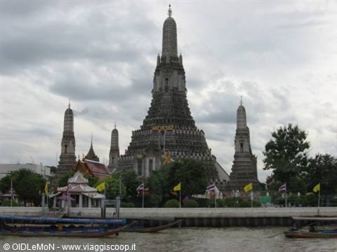 Wat Arun temple in Bangkok seen from the Chao Phraya river with boats