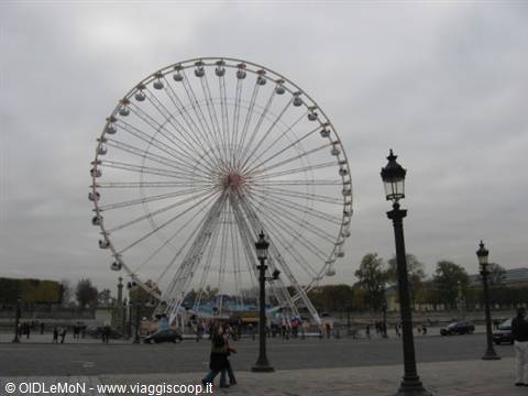 Giant steel Ferris wheel at Place de la Concorde, Paris, grey sky, cast-iron lampposts