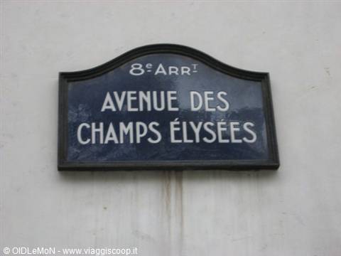 Blue enamel street sign of Avenue des Champs Élysées on a white wall, Paris
