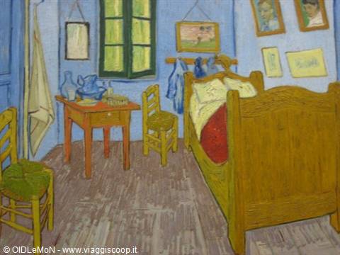 Van Gogh's Bedroom in Arles: wooden bed, chairs, table, blue walls