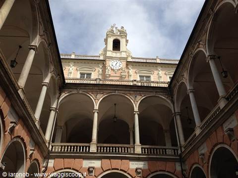 Arcaded courtyard of Palazzo Doria Tursi, Genoa, with clock tower under cloudy sky