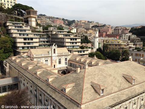 Slate rooftops and historic buildings of Genoa under a cloudy sky