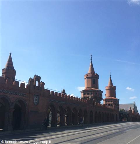 Red brick towers of the Oberbaumbrücke in Berlin under blue sky