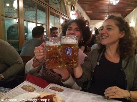 Two women toasting with beer steins at Munich's Hofbräuhaus