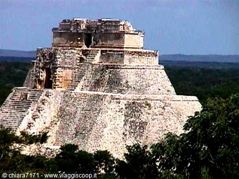 Pyramid of the Magician at Uxmal, limestone in sunlight, green forest below