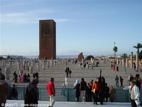 Tourists on the Hassan Tower esplanade in Rabat, stone columns and blue sky