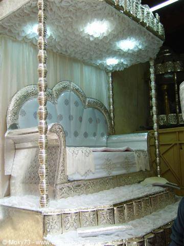 Ornate silver wedding throne under white canopy, Marrakech