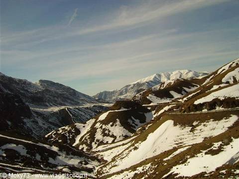 Snowy road winding through the High Atlas mountains, Morocco