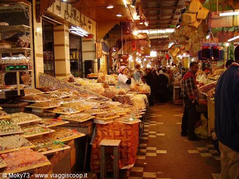 Sweets stalls glowing under lanterns in Marrakech medina souk