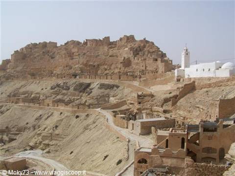 Berber village of earthen houses on the hill, white mosque, Chenini