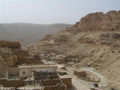 Berber mud-brick village on an arid hillside, cave dwellings at Chenini