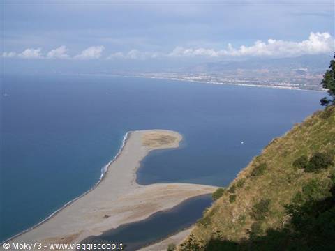 Sandbar and lagoons at Tindari, blue sea beneath green hillsides