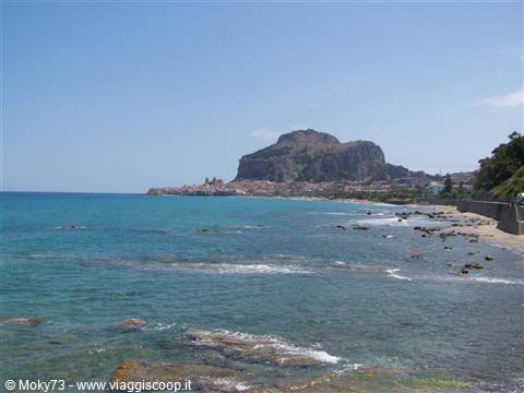Cefalù's Rocca rising above sandy beach and turquoise sea