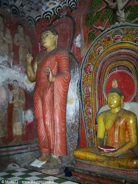 Red and yellow Buddha statues inside the Dambulla cave temple