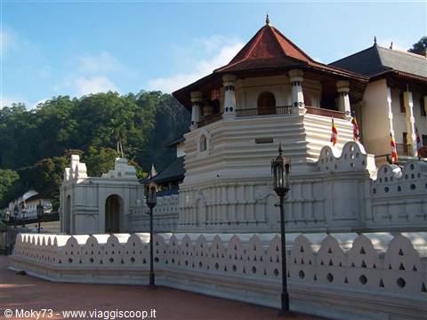Temple of the Tooth in Kandy, white walls and red roof in sunlight
