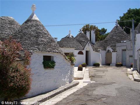 Trulli houses of Alberobello, dry-stone conical roofs under bright sunlight