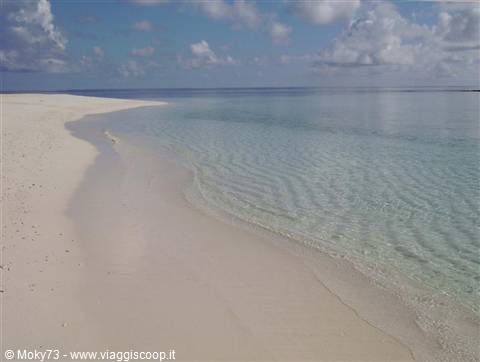 White sand and clear turquoise water on a deserted tropical beach
