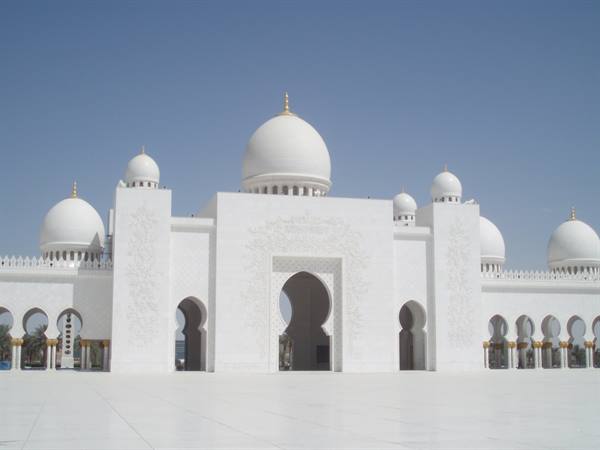 White Sheikh Zayed Mosque in Abu Dhabi, domes and arches under blue sky