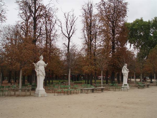 Marble statues and green chairs in the Tuileries Garden, autumn