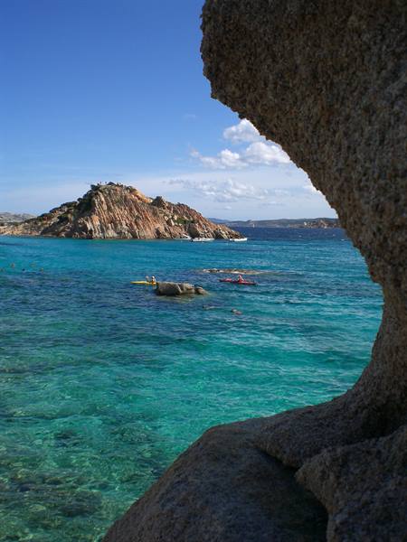 Turquoise waters and kayakers framed by granite, Spargi island
