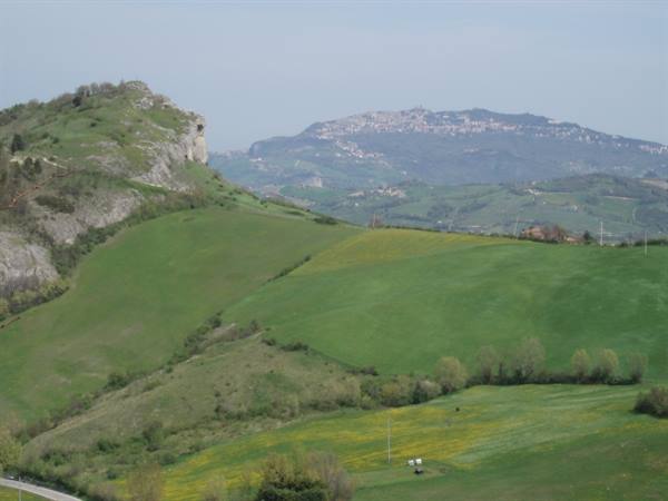Green cultivated hills, hilltop town on the ridge below San Marino