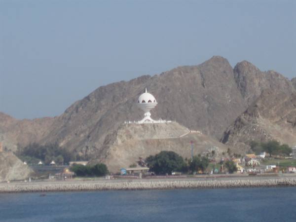The giant white frankincense burner monument in Muscat above the harbor