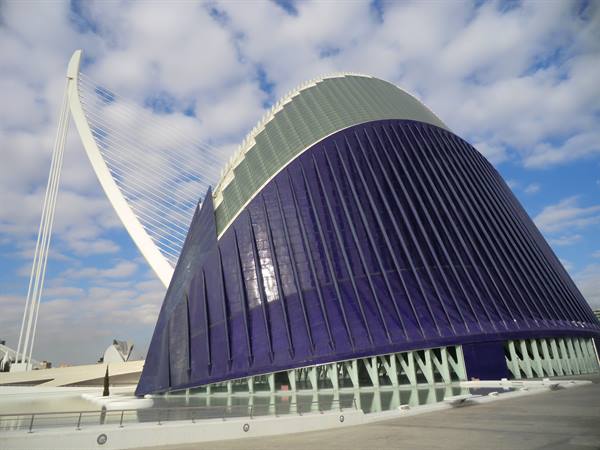 Calatrava's Àgora in Valencia: blue dome and white cable-stayed bridge under clouds