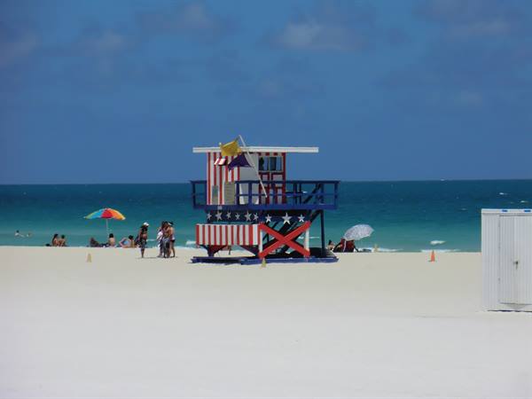 Red, white and blue lifeguard tower on Miami Beach sand
