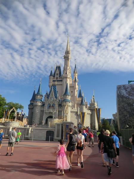 Girl in pink dress walks toward Cinderella Castle, Magic Kingdom