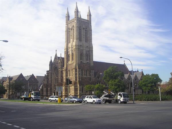St Francis Xavier Cathedral in Adelaide, Gothic stone tower, cars at the intersection