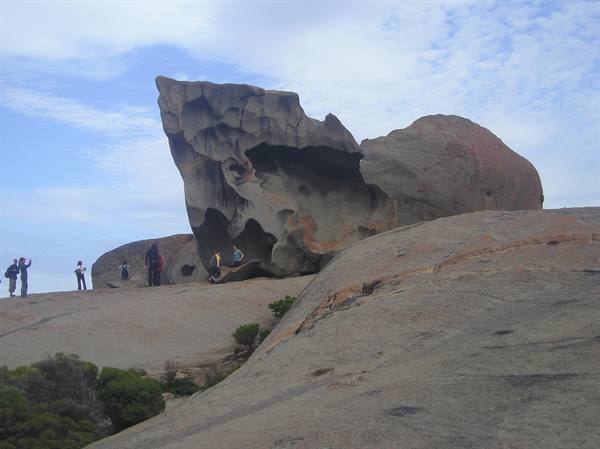 Tourists photograph the wind-sculpted granite of Remarkable Rocks