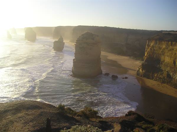The Twelve Apostles, limestone stacks among waves and cliffs in golden light