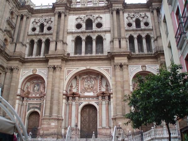 Baroque facade of Málaga cathedral, carved stone, soft daylight