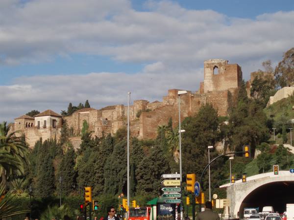 Málaga's Alcazaba fortress rising above city traffic and streetlights