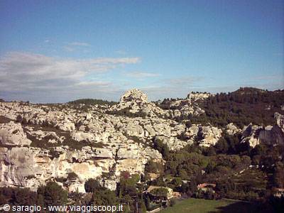White limestone rocks and houses among trees at Les Baux-de-Provence, midday light