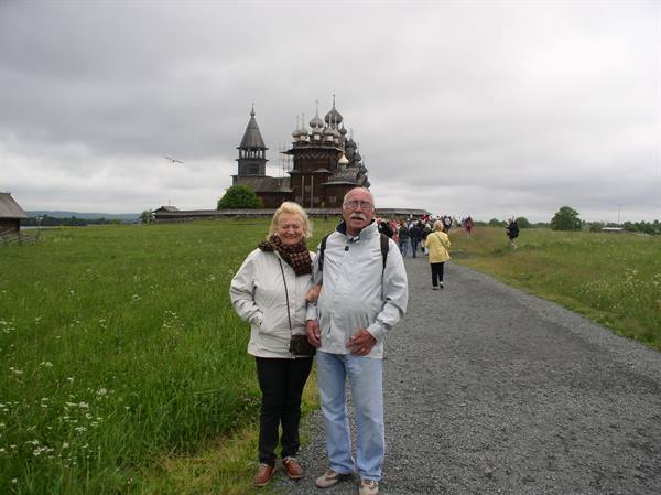 Elderly couple on gravel path in front of Kizhi wooden churches