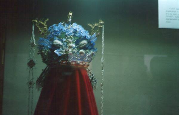 Imperial kingfisher-feather crown with pearls, museum display case, soft lighting