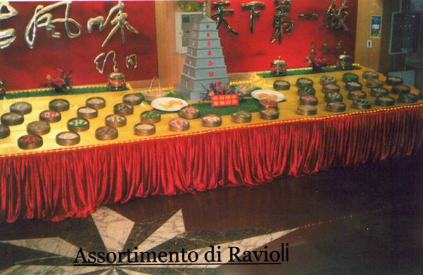 Table laden with dim sum trays, small pagoda model, red banner with gold characters