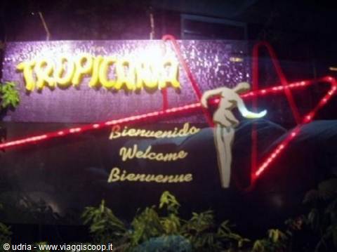 Illuminated Tropicana sign with welcome message and red neon lights