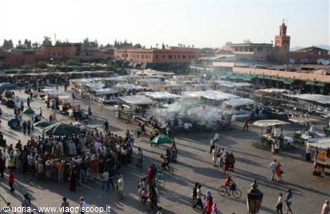 Crowd and smoking food stalls at Jemaa el-Fna square, Marrakech, afternoon light