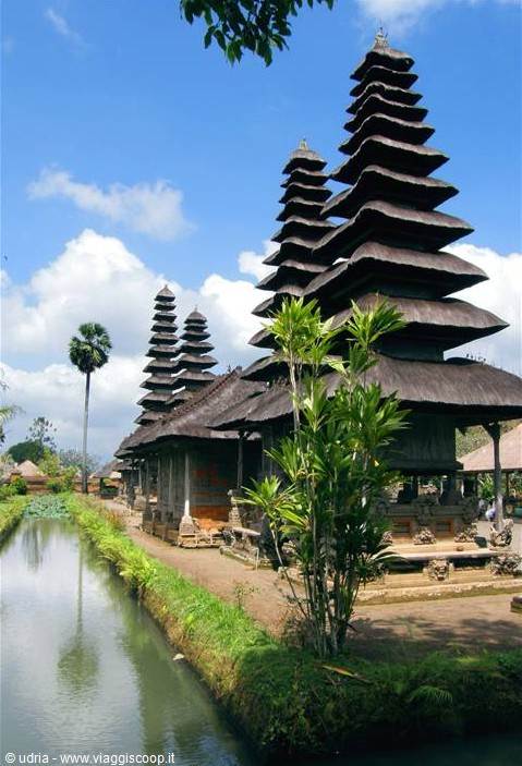Tiered meru pagodas at Taman Ayun temple, Bali, beside green canal
