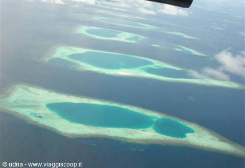 Turquoise coral atolls photographed from the airplane window