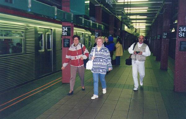 Travelers walking on the 34th Street subway platform, New York