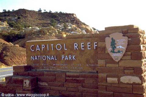 Capitol Reef National Park sign in red sandstone under the sun