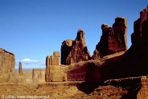 Red sandstone spires rising under a deep blue sky, Arches National Park