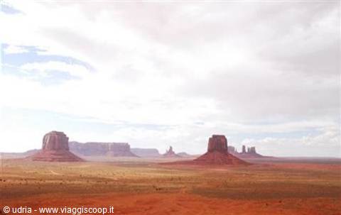 Monument Valley: towering red sandstone buttes under a cloudy sky