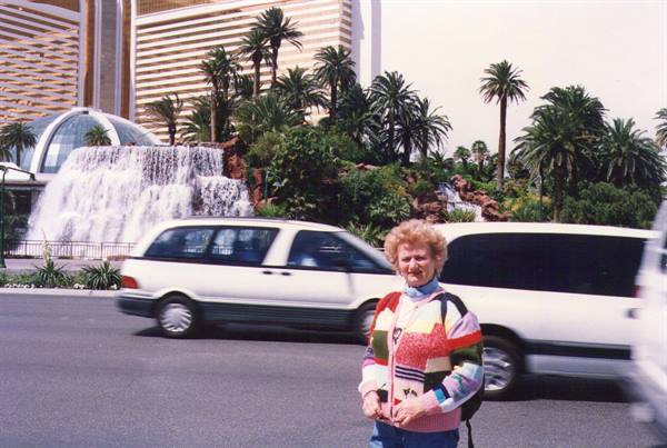 Woman in colorful sweater in front of the Mirage waterfall in Las Vegas