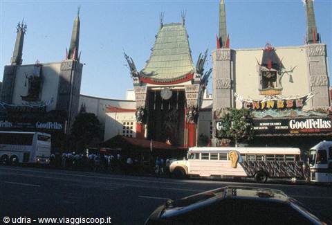 White buses parked in front of Hollywood's Chinese Theatre, Goodfellas sign