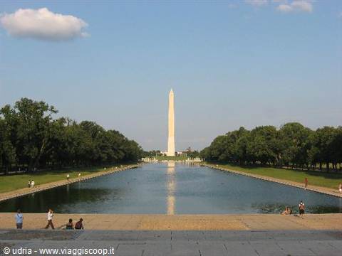 The Washington Monument reflects in the National Mall reflecting pool