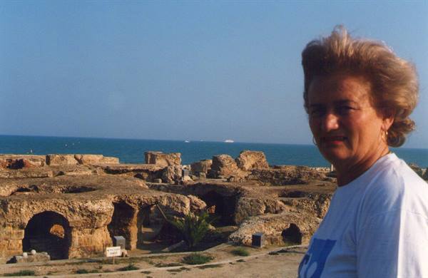 Woman in front of Carthage Roman ruins by the sea